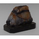 A Derbyshire Blue John specimen, cut and polished to one face, the verso in the raw,