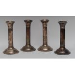 A set of four George V silver Doric column candlesticks, domed circular bases, 18.