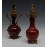 A near pair of ormolu mounted Chinese sang de boeuf bottle vases,