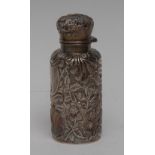 A George V silver cylindrical smelling salts/scent bottle, embossed overall with shield,
