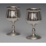 A pair of Elizabeth II silver pedestal wine goblets, bell shaped bowls, baluster stems,