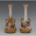 A pair of Royal Worcester bottle vases, painted with red and yellow cabbage roses,