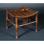 An Arts and Crafts oak Thebes stool, in the manner of Liberty & Co.