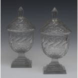 A pair of 19th century clear glass sweetmeat urns and covers, faceted knop finials,