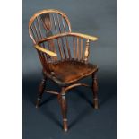 A 19th century elm Windsor elbow chair, low hooped back with shaped and pierced splats, saddle seat,