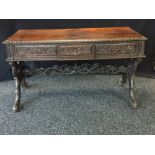 An oriental hardwood library table, rectangular top, frieze drawer, X-frame end supports,