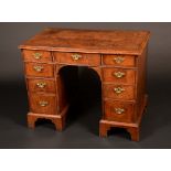 An early 18th century walnut kneehole desk,