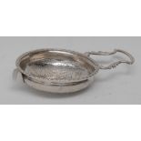 An early George III silver lemon strainer, pierced bowl with gadrooned border, shaped lug handle,