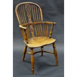 An early 19th century yew and elm Windsor elbow chair, hooped back with shaped and pierced s[plat,