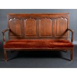 A George III oak settle, rectangular back with five shaped arched and fielded panels,