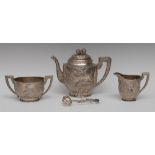 A Chinese silver oval three piece tea service, comprising teapot,