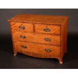 A 19th century satinwood chest of three long graduated cockbeaded drawers, oval brass handles,