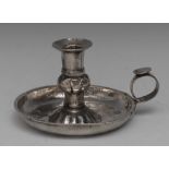 An 18th/19th century silver chamberstick, possibly South American, flared sconce with fluted socle,