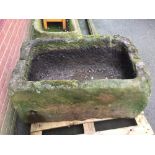 A hewn stone trough 50cm high x 105cm long x 69cm wide