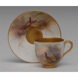 A Royal Worcester cabinet cup and saucer, painted by Jas Stinton, signed,