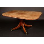 A Regency rounded rectangular mahogany breakfast table, reeded tilting-top,