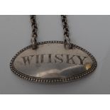 A Victorian silver oval wine label, Whisky, engraved lettering, beaded border, 4.