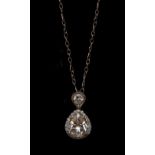 A diamond pendant, principle tear drop diamond, surrounded by a band of round cut diamonds,