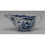 A Bow sauceboat, painted in underglaze blue with a Chinese landscape, the interior with peony,