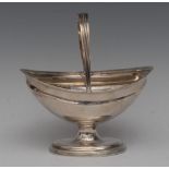 A George III silver boat shaped pedestal sugar basket, swing handle, reeded borders, 14.