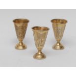 A set of three Austro-Hungarian silver-gilt tapered cylindrical tots,