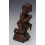 An 18th/19th century oak carving, of a scantily draped putto, kneeling,