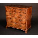 A George II crossbanded walnut chest, moulded top above two short and three long graduated drawers,