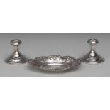 An Italian silver oval dish, chased with a border of flowers and scrolling foliage,