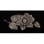 A diamond encrusted floral brooch, pave encrusted with diamonds,