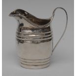 A George III silver bowed cream jug, ribbed girdles, scroll handle, reeded rim, 12cm high,