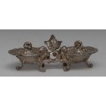 A Continental Rococo silver shell shaped twin-compartment dish, hinged covers, acanthus scroll feet,