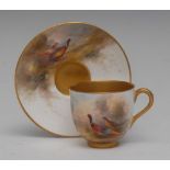 A Royal Worcester cabinet cup and saucer, painted by Jas Stinton, signed,