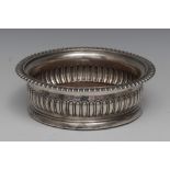 A George III silver circular fluted wine coaster, gadrooned rim, draught turned base, crested, 16.