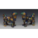 A pair of Chinese models of dogs, each standing four square, with tail curled,