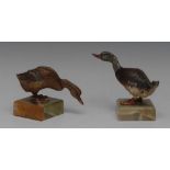 A pair of Austrian cold painted models of geese, naturalistically coloured, green onyx square bases,
