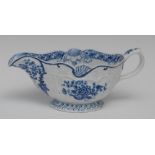 A Bow sauce boat, of Rococo silver form, printed in underglaze blue with blossoming flowers,