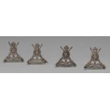 Military - a set of four Edwardian silver novelty menu holders,