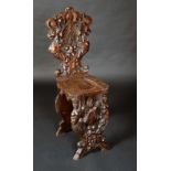 A 19th century Italian hall chair, cartouche-shaped back and underframe boldly carved with griffins,