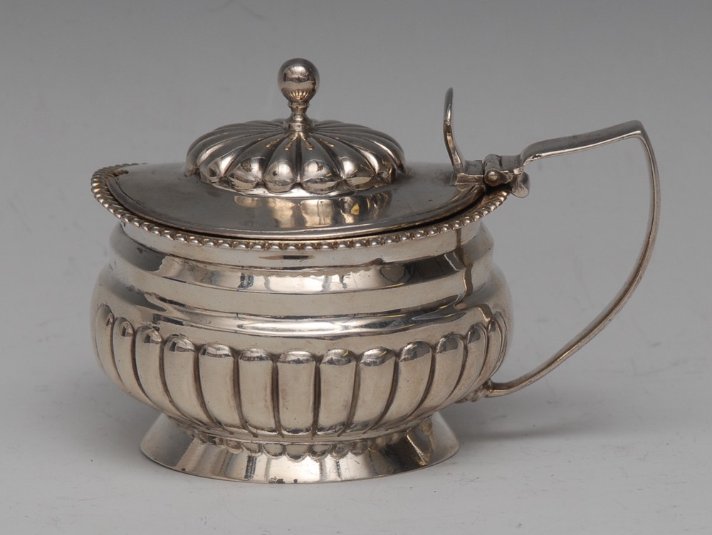 A George III half fluted circular mustard, hinged cover, angular scroll handle, 10cm wide,