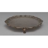 A George II silver shaped circular salver, fluted shell and scroll border, hoof feet, 16cm diam,
