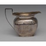 A George III silver boat shaped milk jug,