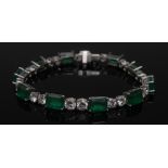 An emerald and diamond bracelet, set with ten green emerald baguettes,