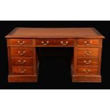 An early 20th century mahogany twin-pedestal desk,