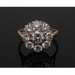 A diamond floral cluster ring, central round brilliant cut diamond approx 0.