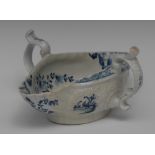 A Worcester two handled double lipped sauceboat, painted with an interior Chinese landscape,