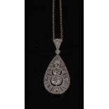 An Art Deco style diamond teardrop pendant, inset with fifteen cushion,