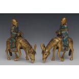 A pair of 19th century Chinese cloisonne models of scholars riding donkeys,