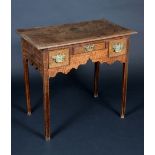 A George III oak lowboy, moulded oversailing top above a shaped frieze with three drawers,