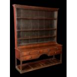 An 18th century oak dresser, outswept cornice above four shelves,