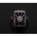 An Art Deco style diamond and sapphire cluster ring, central round brilliant cut diamond approx 0.